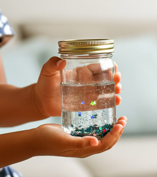 child holding a jar with glitter for mindfulness