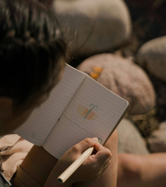 a child drawing in a gratitude journal